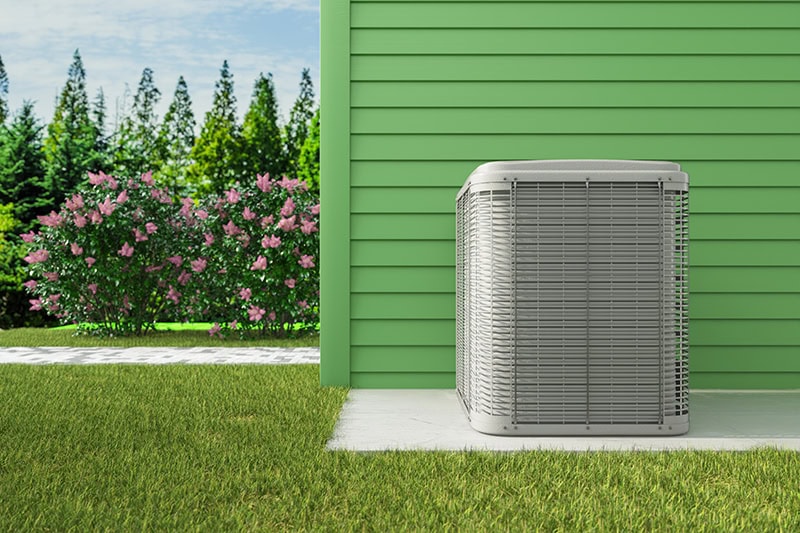 A new AC unit outside on a slab.