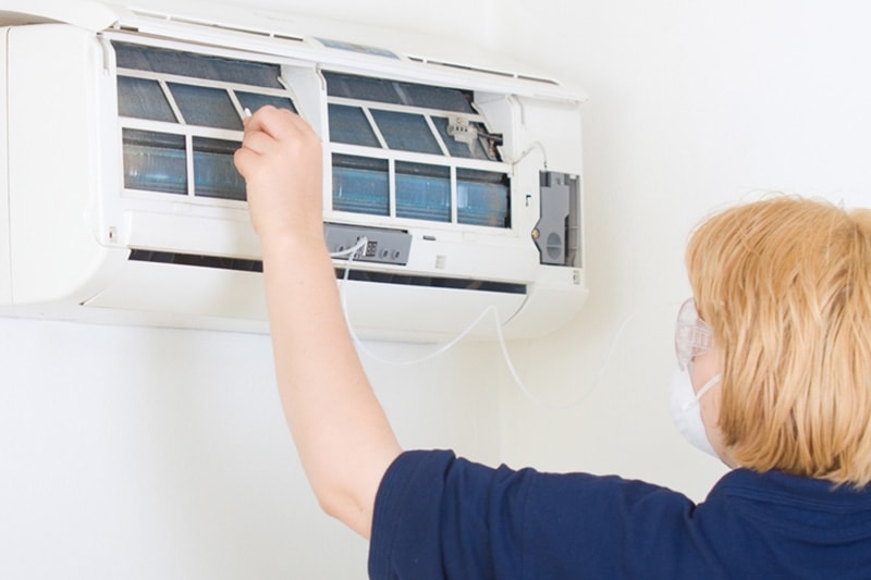 HVAC Worker Repairing a Ductless System.