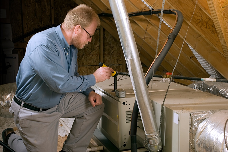 HVAC Technician performing maintenance on a heat pump.