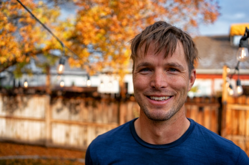 Homeowner with smile on his face posing for photo after receiving Fall HVAC maintenance.